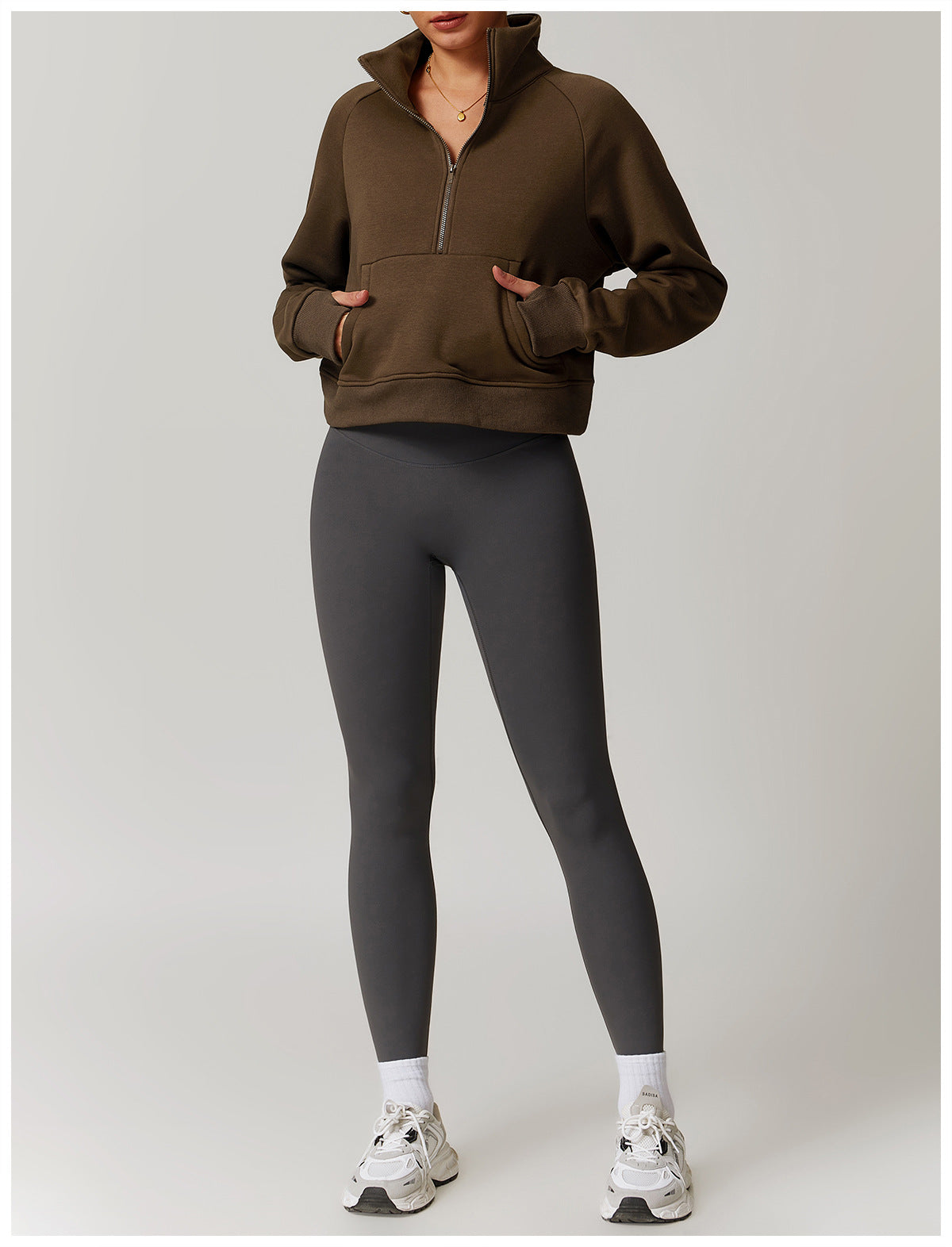 Brown half-zip pullover sweater with pockets styled with grey leggings and white sneakers, fashion ملابس