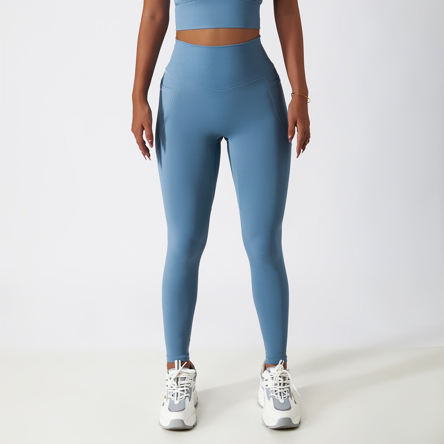 High-waisted blue athletic leggings with white sneakers for fashionable yoga or langry