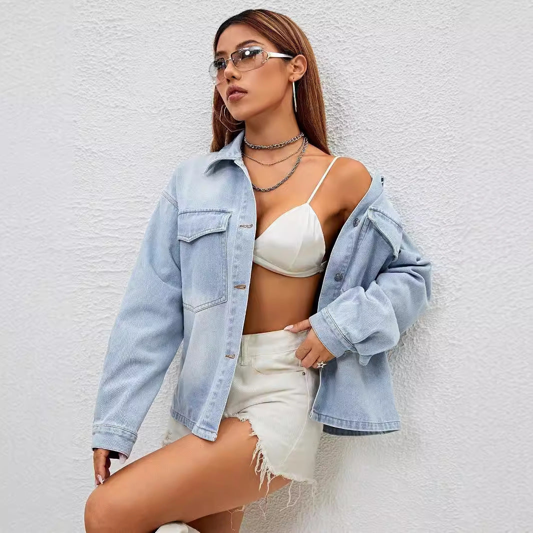 Fashionable loose denim coat worn with white bralette and distressed shorts for a trendy look