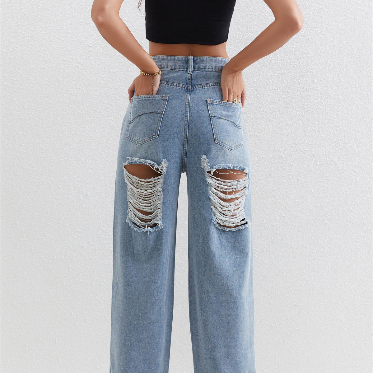 Light blue distressed wide-leg jeans with rips, perfect for stylish ملابس fashion