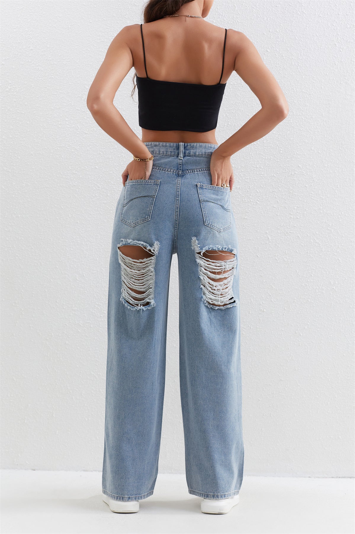 Light blue distressed wide-leg jeans with rips, perfect for stylish ملابس fashion