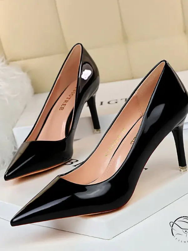 Pair of fashionable black patent leather stiletto heels