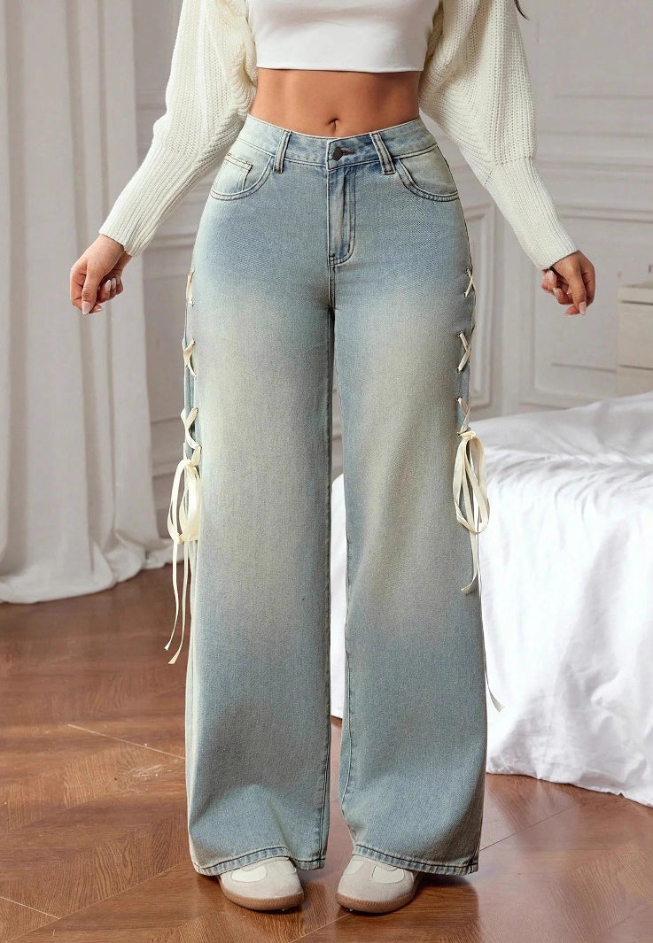 Light-wash high-rise wide leg jeans with cream lace-up side ties