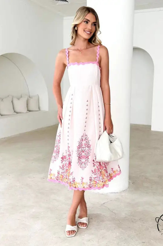 Attractive backless dress in white with pink floral hem embroidery