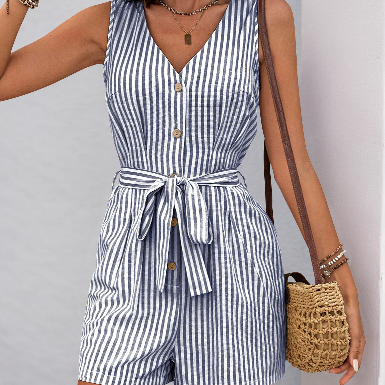 Sleeveless striped romper with v-neck and waist tie, perfect for summer fashion ملابس