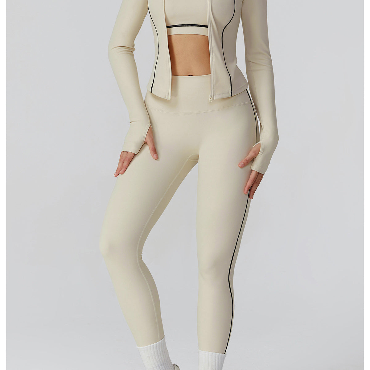 Langry beige zip-up windproof jacket with black piping and white sneakers