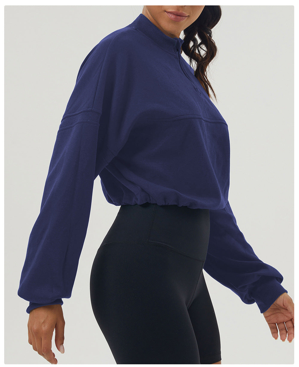 Navy cropped long sleeve sweatshirt paired with black biker shorts for casual fashion