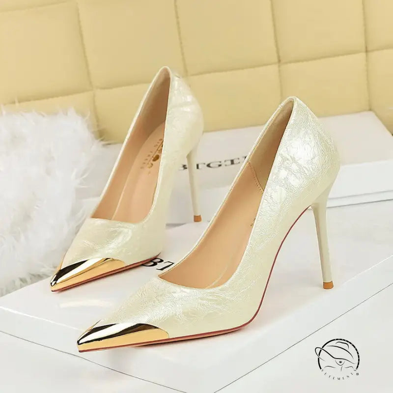 Cream patent leather super high heel pumps with metal pointed accents by Langry