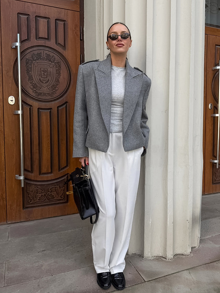 Langry fashion gray textured blazer with white pants and black accessories