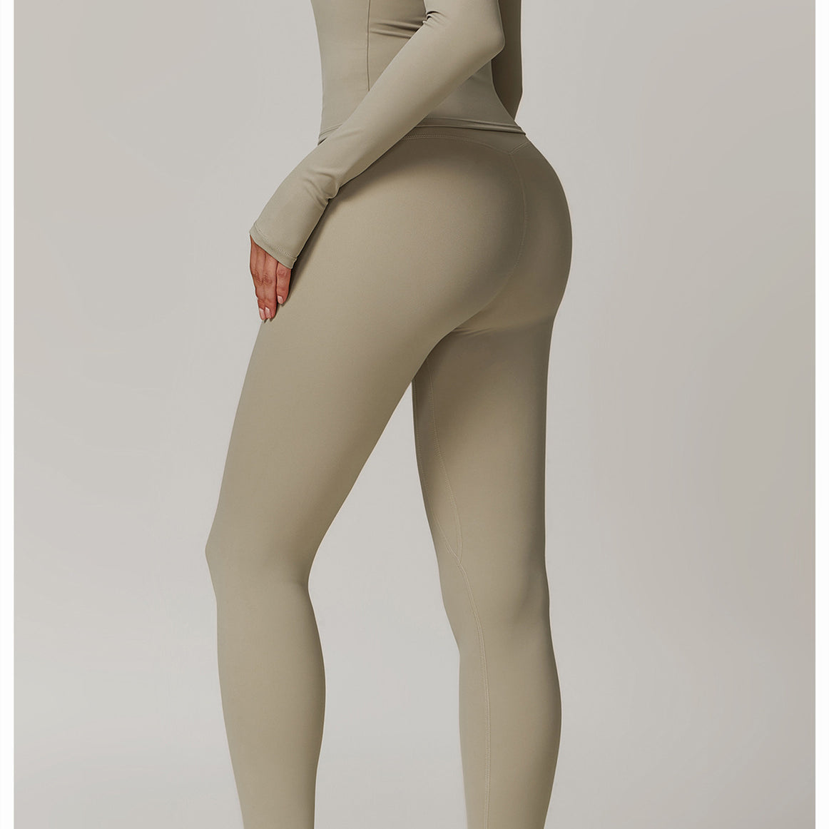 Beige athletic bodysuit with white sneakers for outdoor running sports fitness in modern fashion