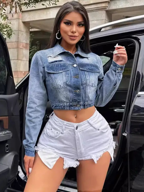 Woman in loose short denim coat with blue jacket and white shorts