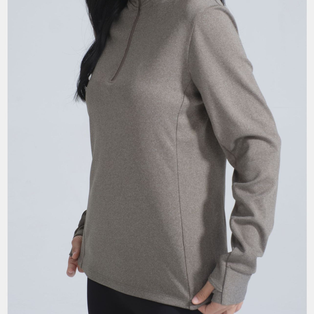 Woman wearing Winter Thermal Velvet Long Sleeved Yoga Jacket in muted olive-green with thumbholes