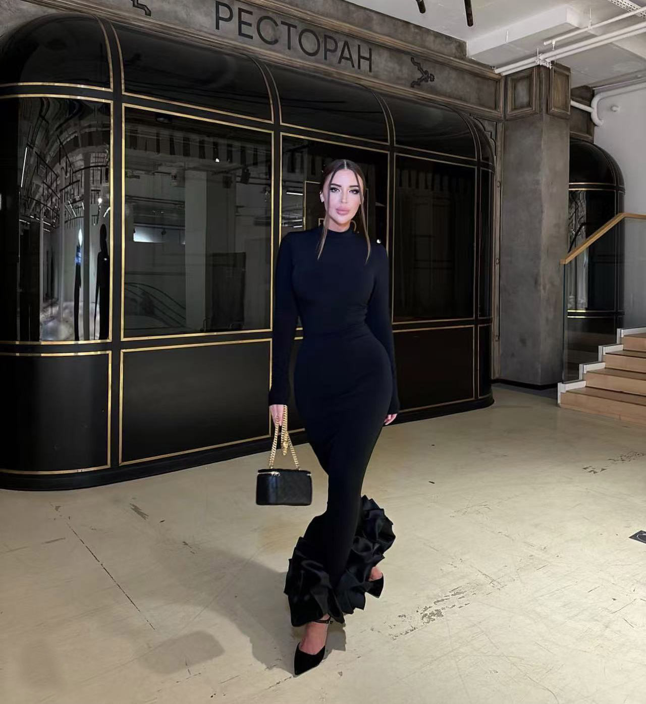 Elegant black fishtail dress with ruffled hem showcasing sophisticated fashion and ملابس style