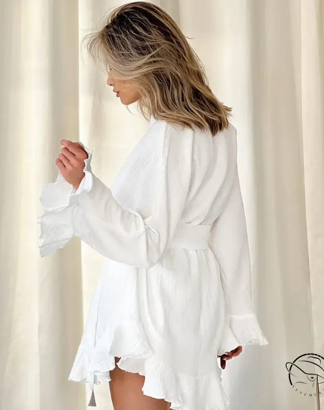 Woman in white ruffled long-sleeve mini dress from loose shorts ruffled pajamas