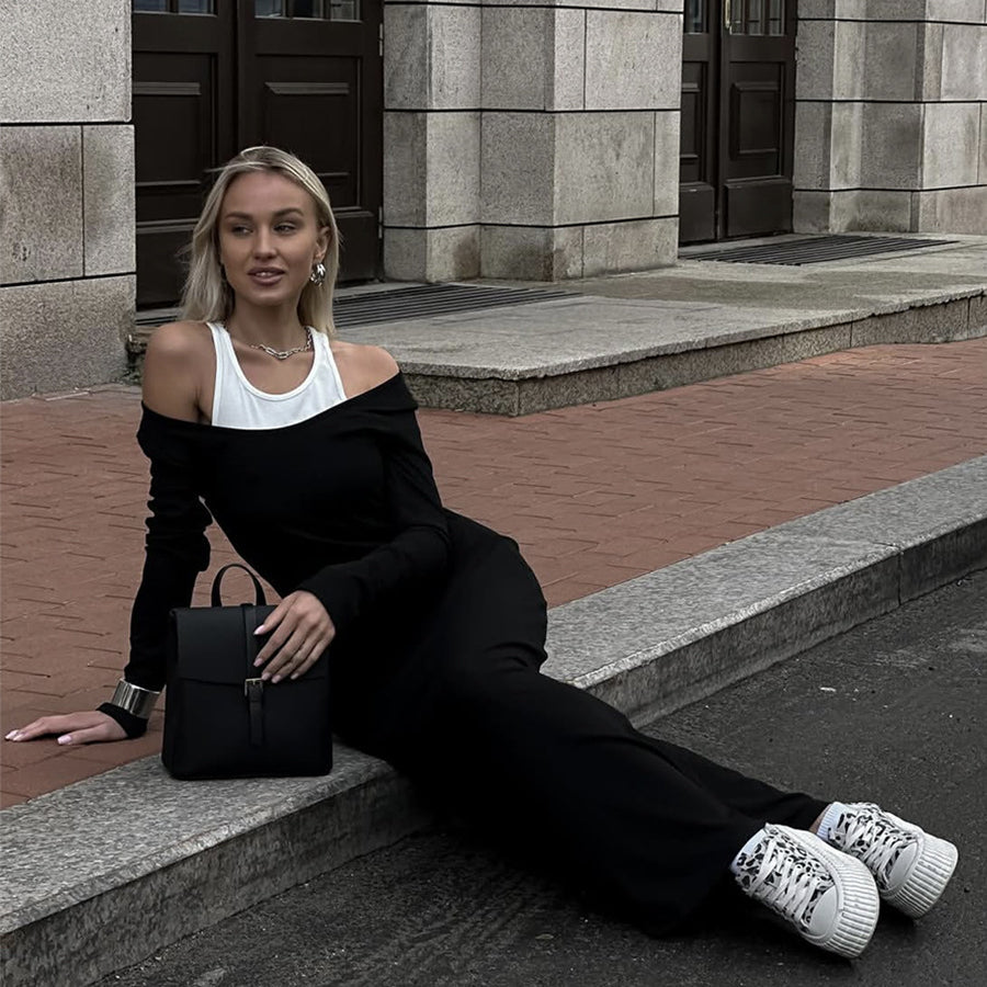 A person in a black off-shoulder outfit showcasing the Attractive Two Piece Vest Dress