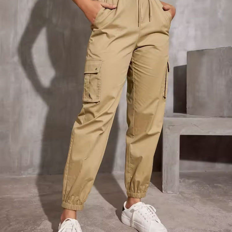Khaki cargo jogger pants with elastic waistband, styled with white sneakers for trendy fashion
