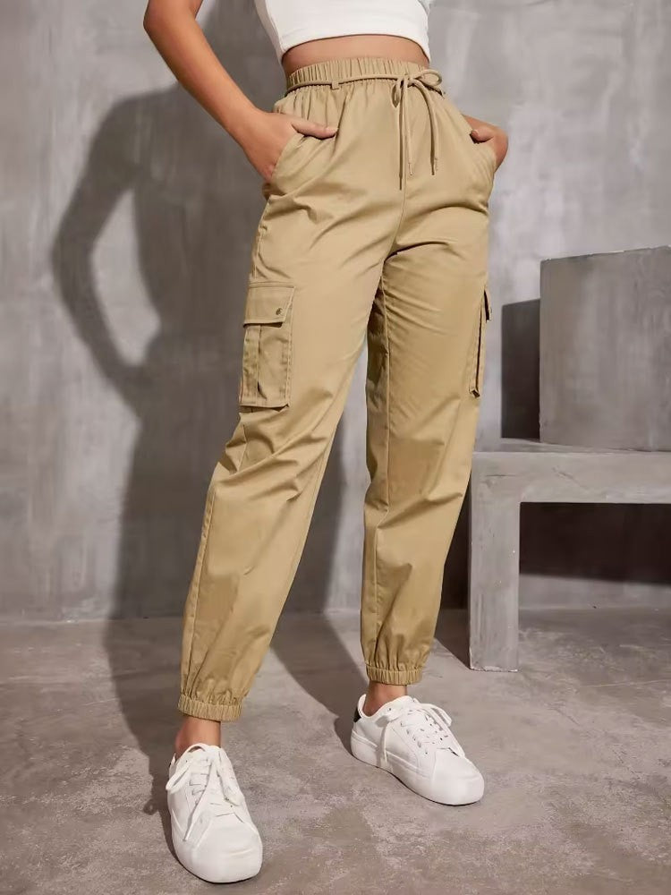 Khaki cargo jogger pants with elastic waistband, styled with white sneakers for trendy fashion
