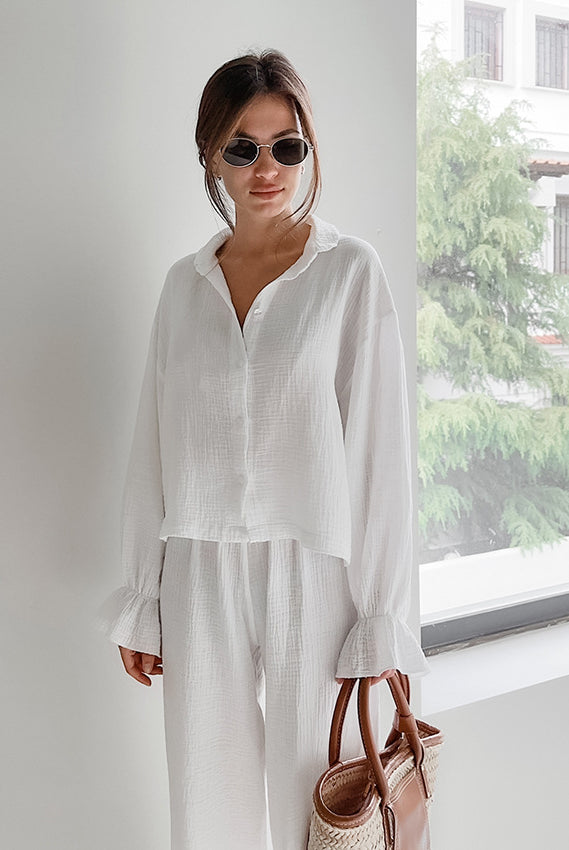 Woman in white pure cotton casual outfit with straw handbag for comfortable homewear