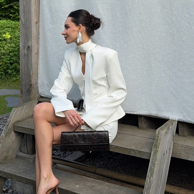 Langry fashion white high-neck blouse with bell sleeves and black clutch