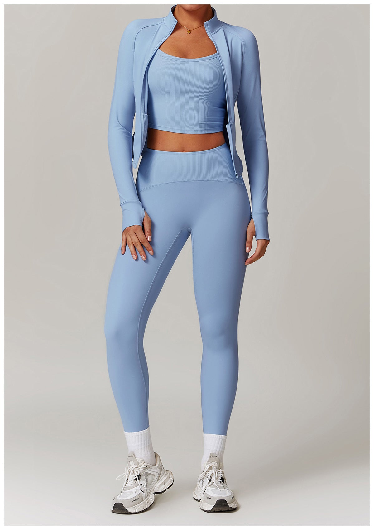 Light blue langry workout set with cropped jacket, sports bra, leggings, and white sneakers