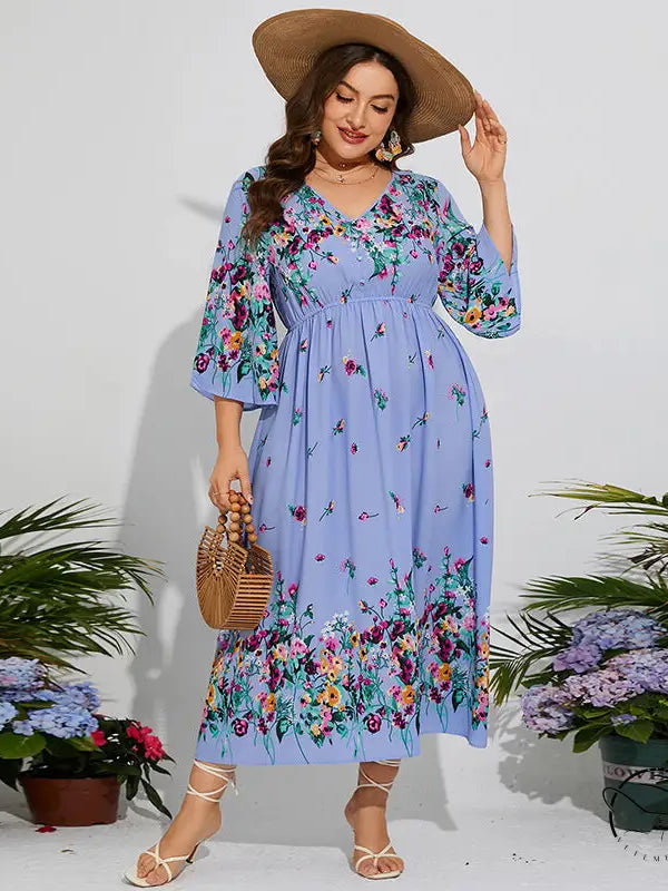 Woman in floral chiffon spring dress with elastic waist, V-neck, ruffles, hat, bag, heels