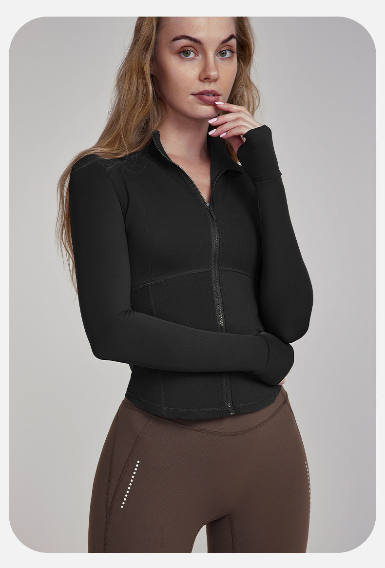 Woman wearing a black zip-up athletic jacket and brown leggings from Slim Fit Breathable Yoga Jacket collection