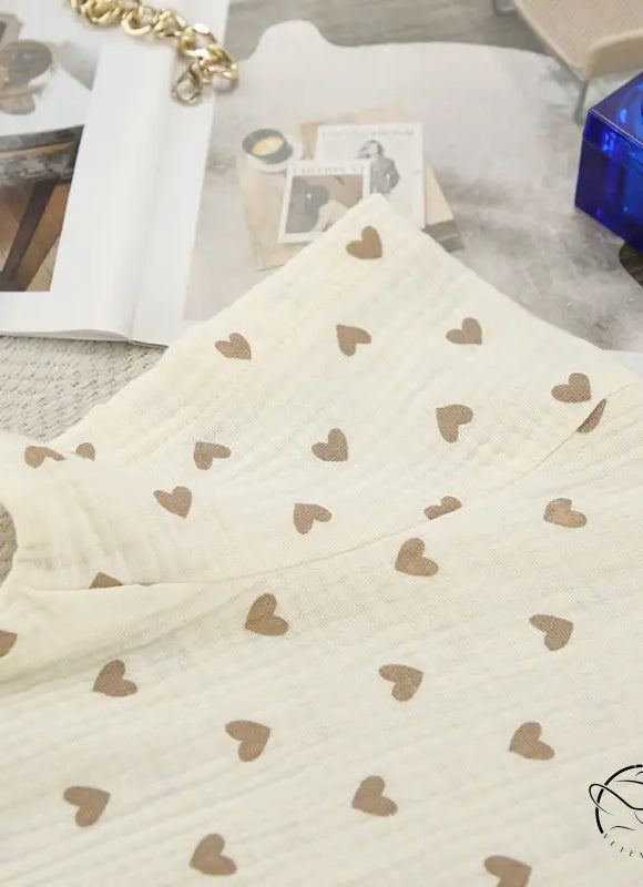 Cream-colored cotton linen fabric with brown heart patterns on summer slit shorts set