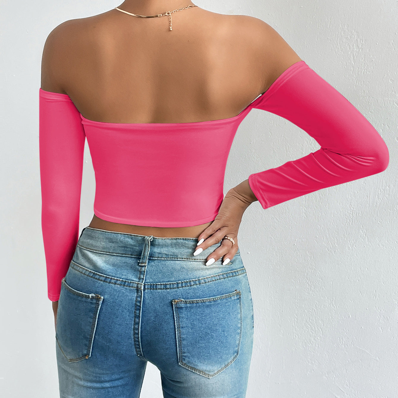 Bright pink off-the-shoulder crop top with light wash jeans, stylish ملابس fashion piece