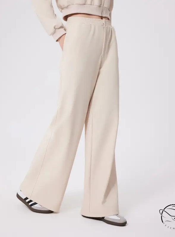 Cream-colored loose fitness warm pants with relaxed fit and elastic waistband