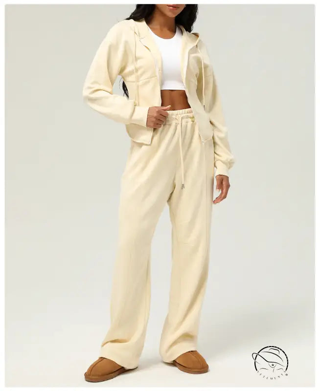 Woman in cream-colored lounge set wearing casual cardigan sweater