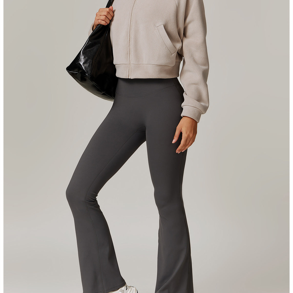 Gray flared yoga pants with beige turtleneck and white sneakers for stylish fitness wear