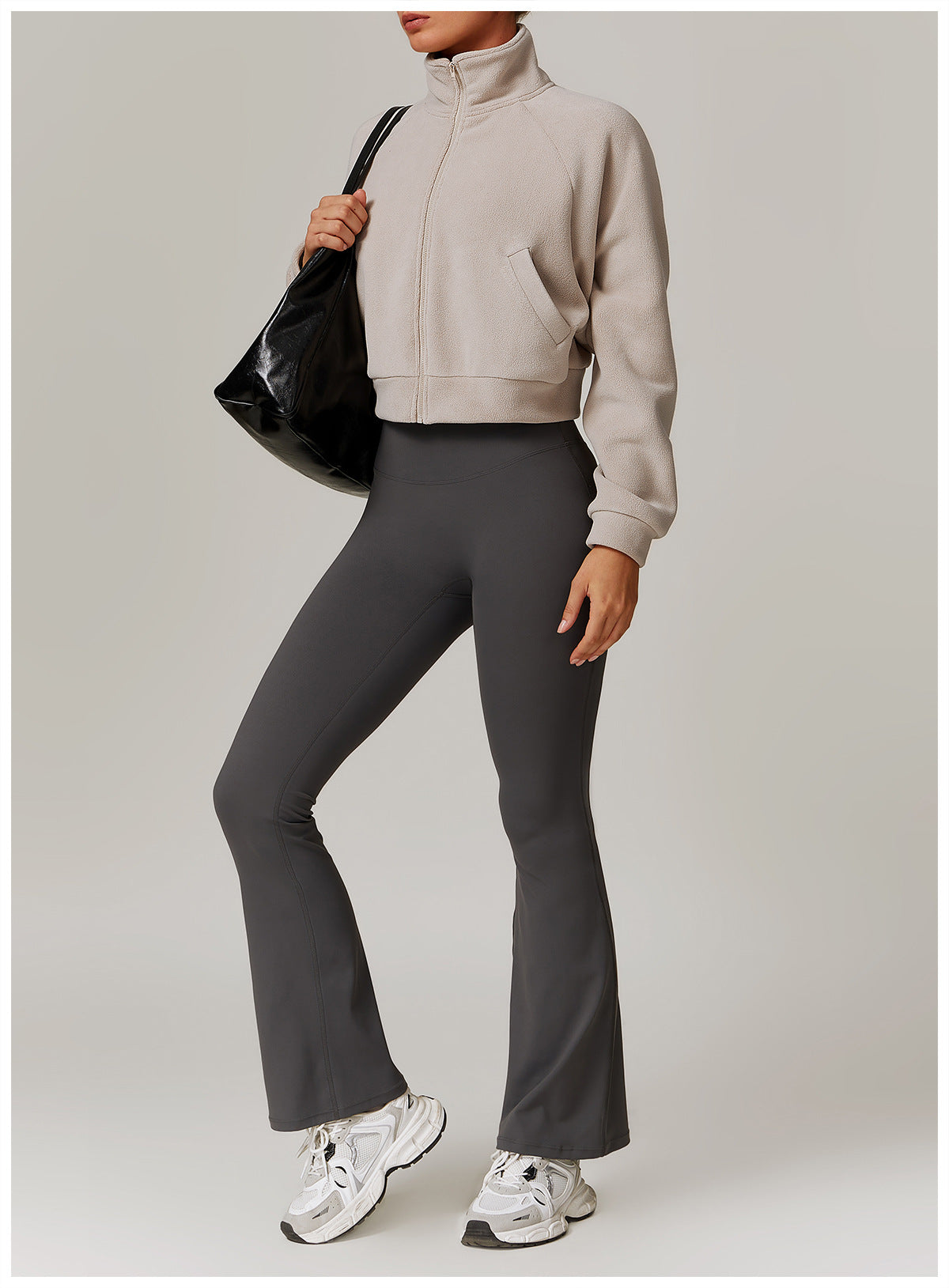 Gray flared yoga pants with beige turtleneck and white sneakers for stylish fitness wear