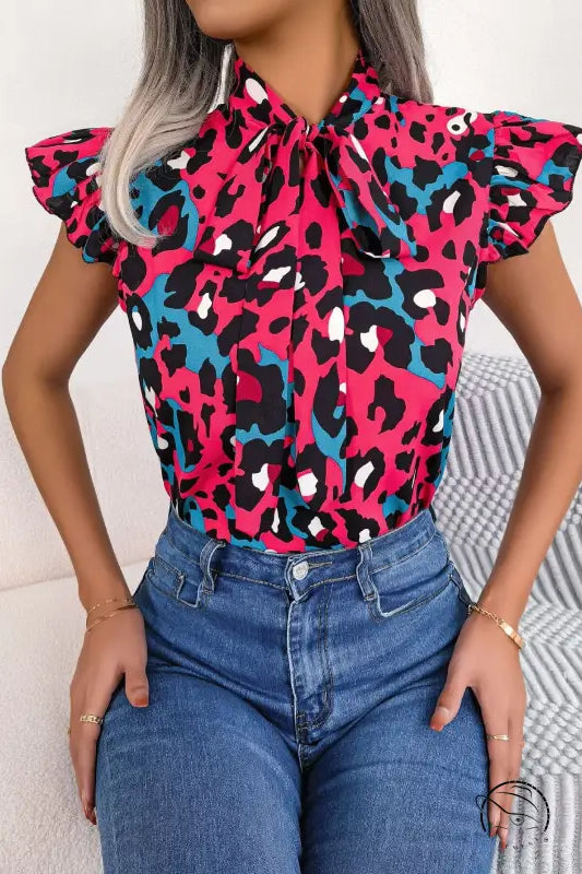 Vibrant casual leopard print blouse with pink, blue, black pattern, ruffled sleeves, tie-neck collar