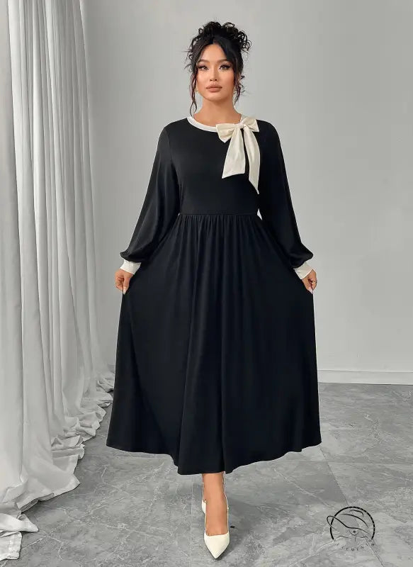 Winter retro slim black dress with flared sleeves and bow neckline in satin