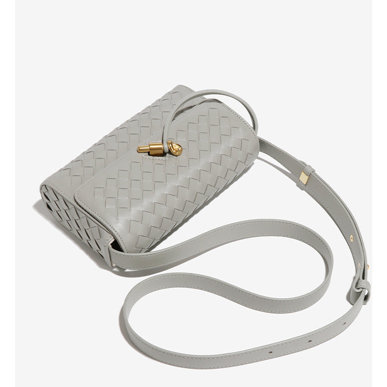 Gray woven leather crossbody bag with gold clasp, perfect for stylish fashion looks