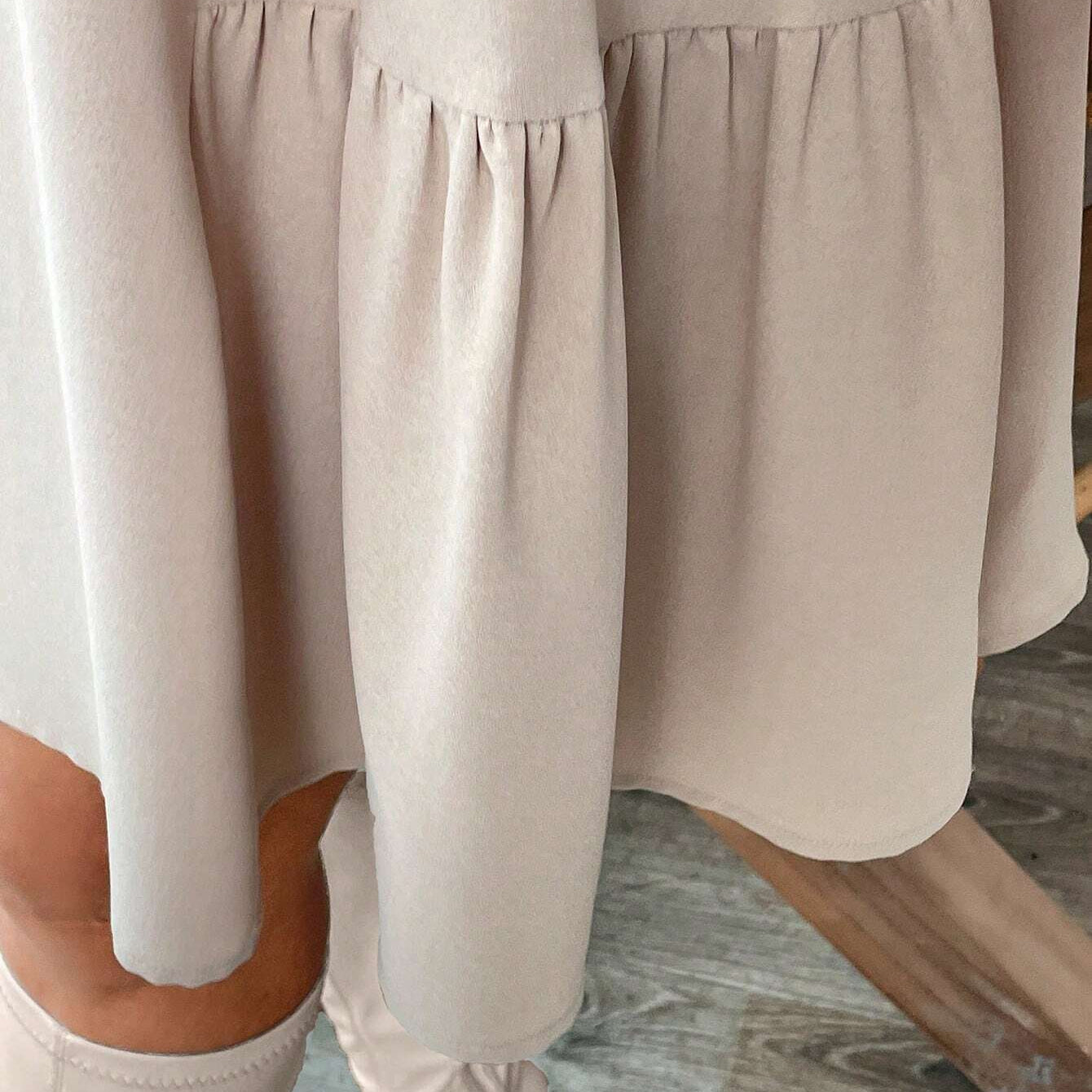 Beige tiered midi dress with long sleeves and ruffled hem for stylish winter fashion