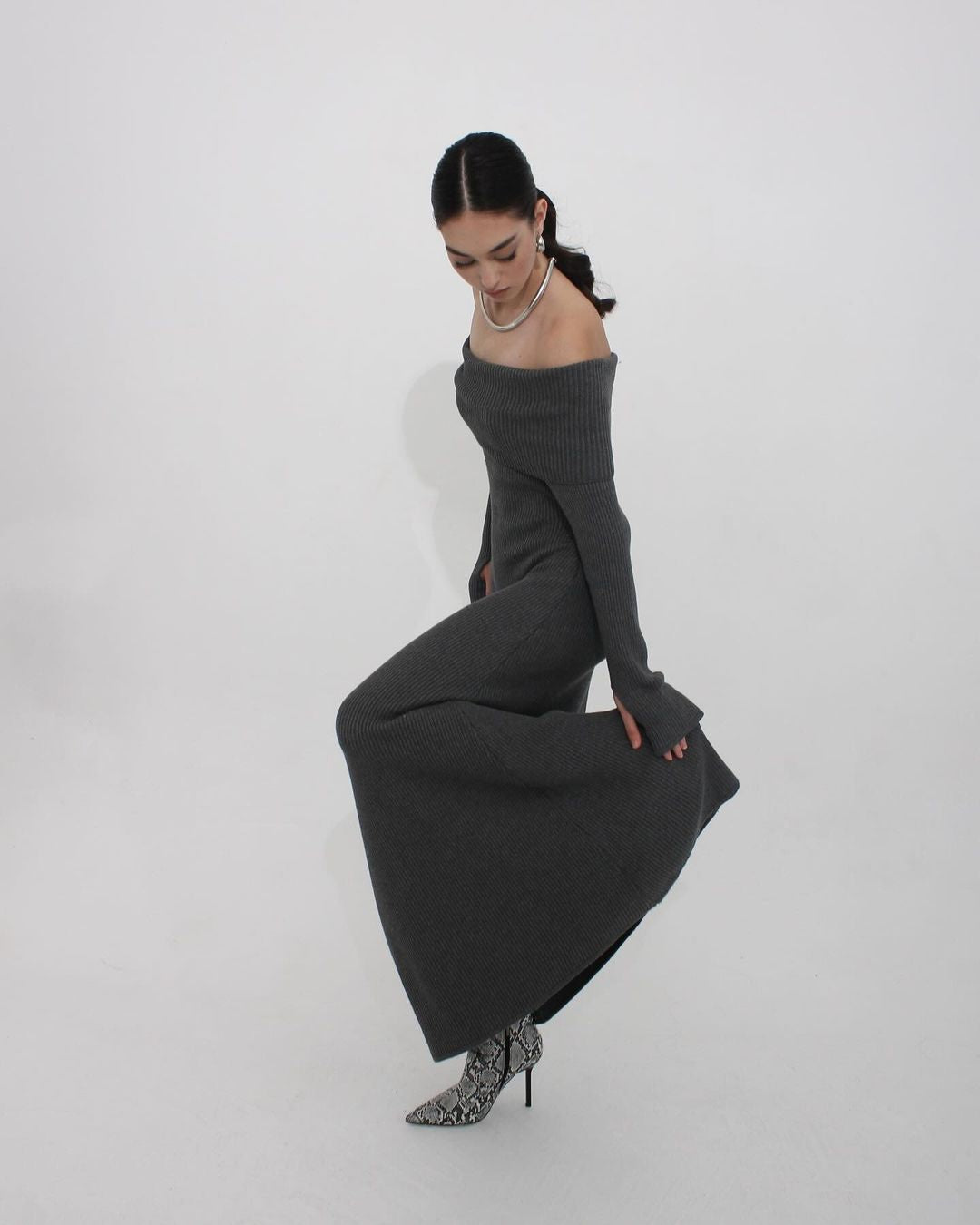 Elegant off-shoulder formal dress with gray knit fabric and snake print boots for stylish fashion