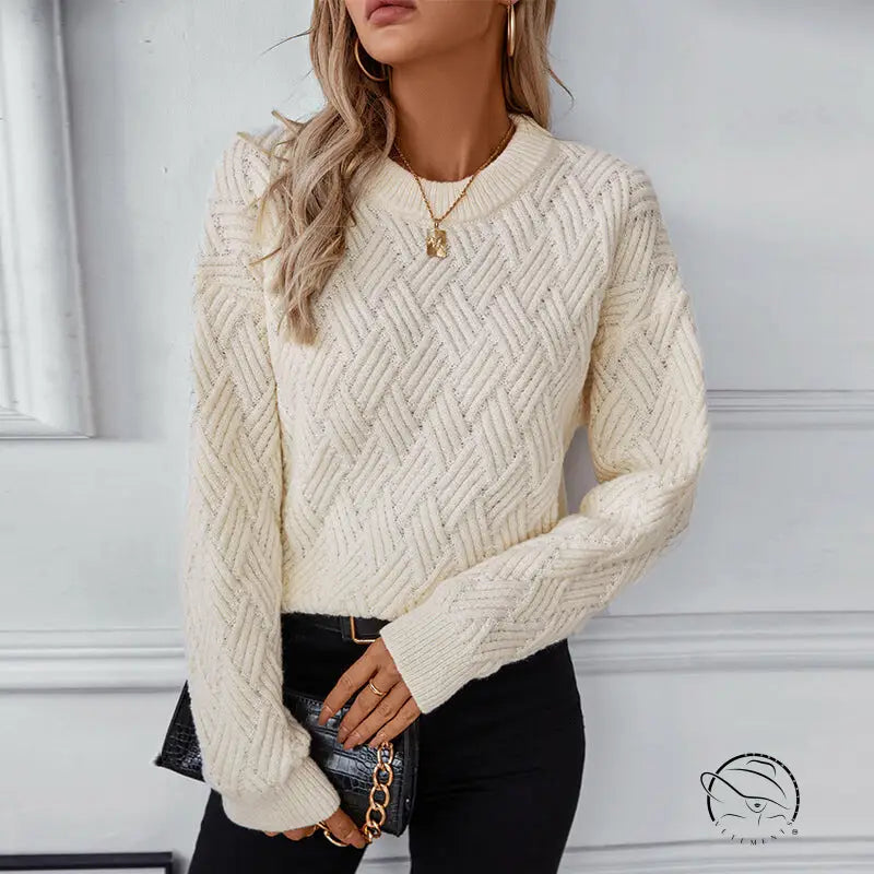 Winter retro crew neck knitwear: cream herringbone sweater, black pants, gold necklace