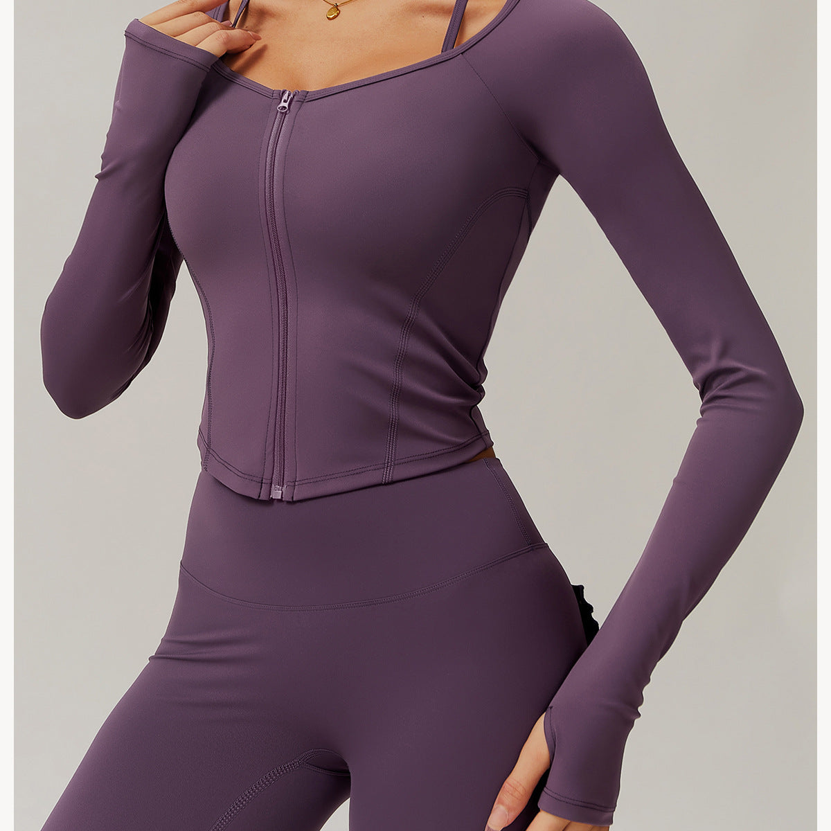 Purple zip-front athletic jumpsuit, perfect for yoga and stylish fitness fashion ملابس