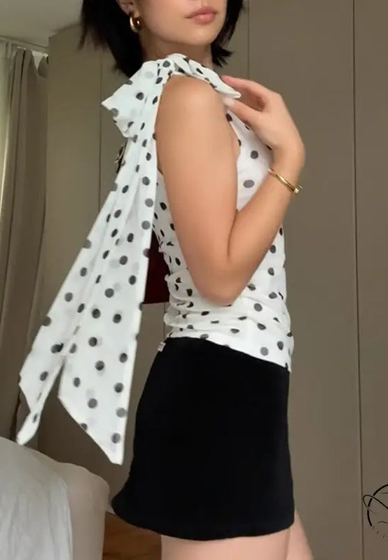 Polka dot blouse with ruffled sleeves and black skirt in Langry fashion