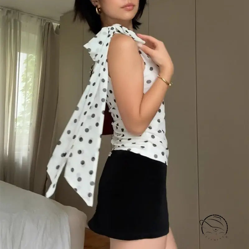 Polka dot blouse with ruffled sleeves and black skirt in Langry fashion