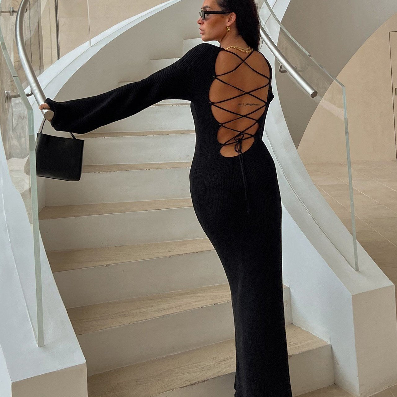 Long black dress with laced-up back detail and platform heels for stylish fashion ملابس