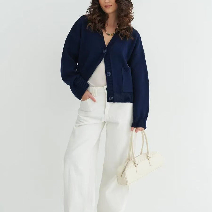 Navy blue knitted cardigan sweater coat with balloon sleeves and white wide-leg pants