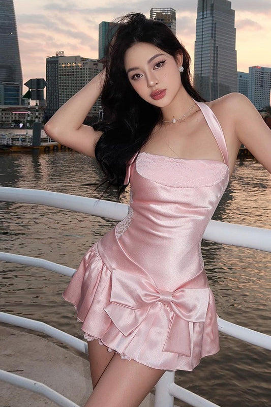 Pink satin mini dress with ruffled skirt and halter neckline for stylish fashion statement
