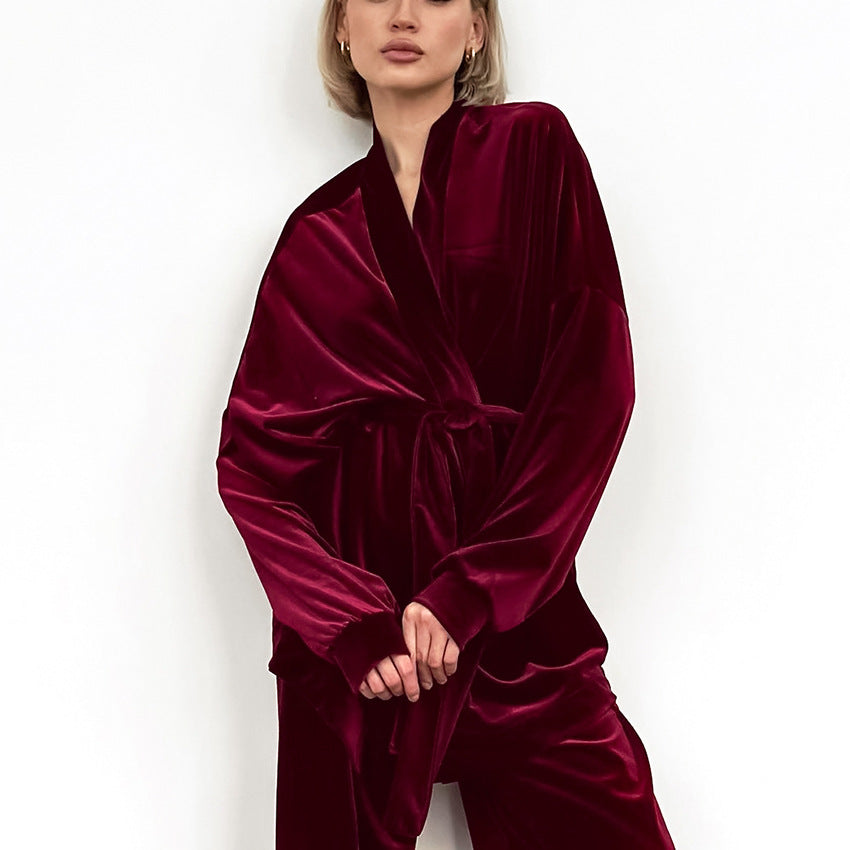 Woman wearing luxurious deep red velvet comfortable cardigan thermal pajamas set