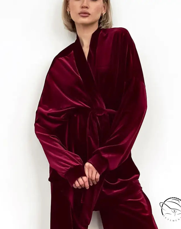 Woman in luxurious deep red velvet comfortable cardigan thermal pajamas