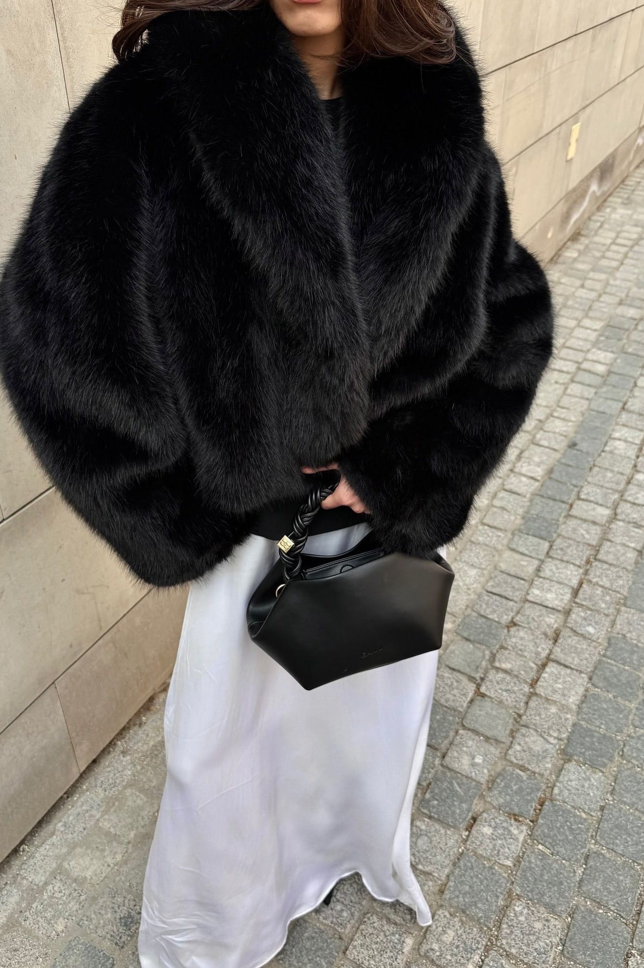 Cozy short faux fur coat with black fur, high collar, and long sleeves