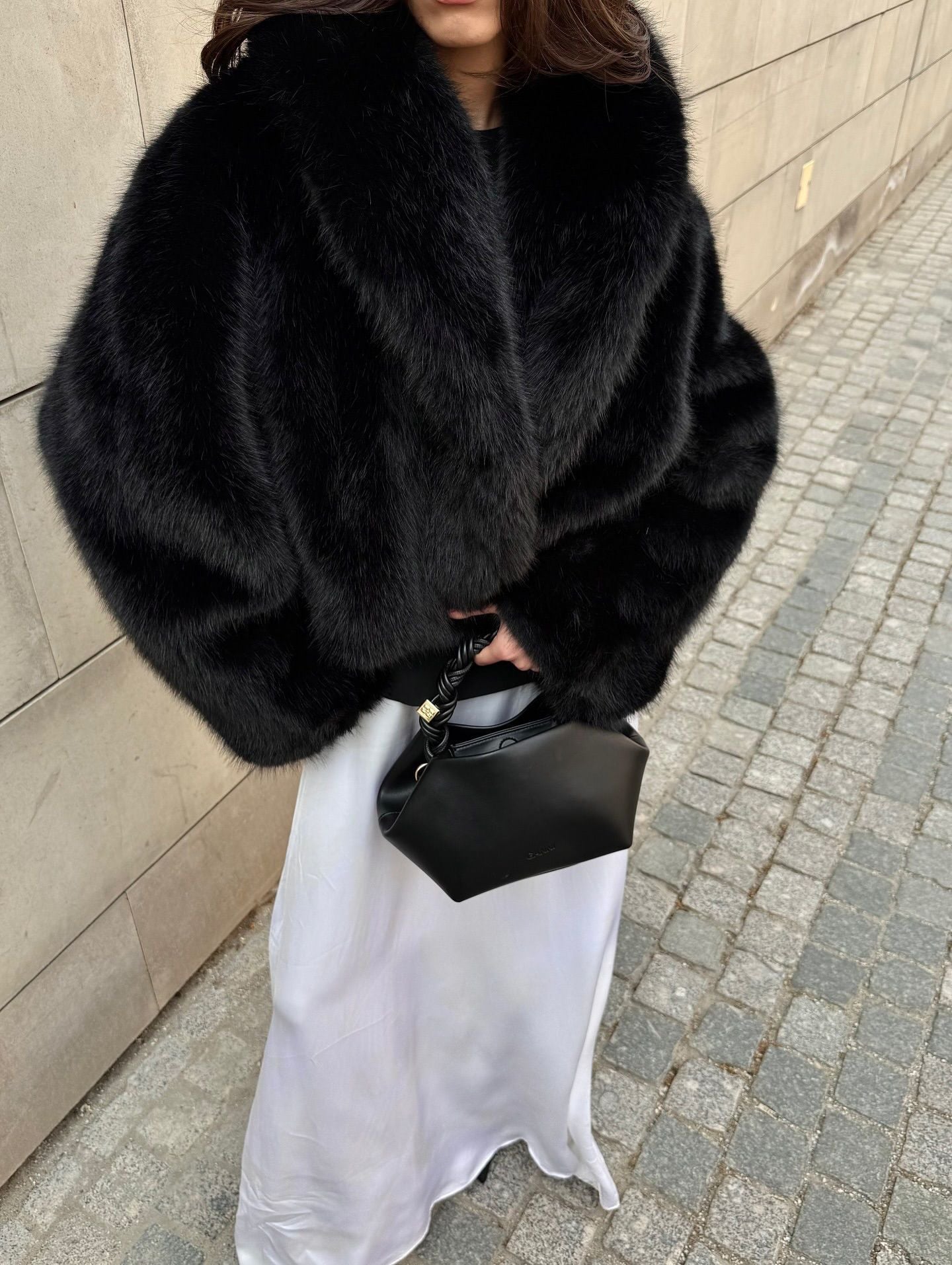 Cozy short faux fur coat with black fur, high collar, and long sleeves