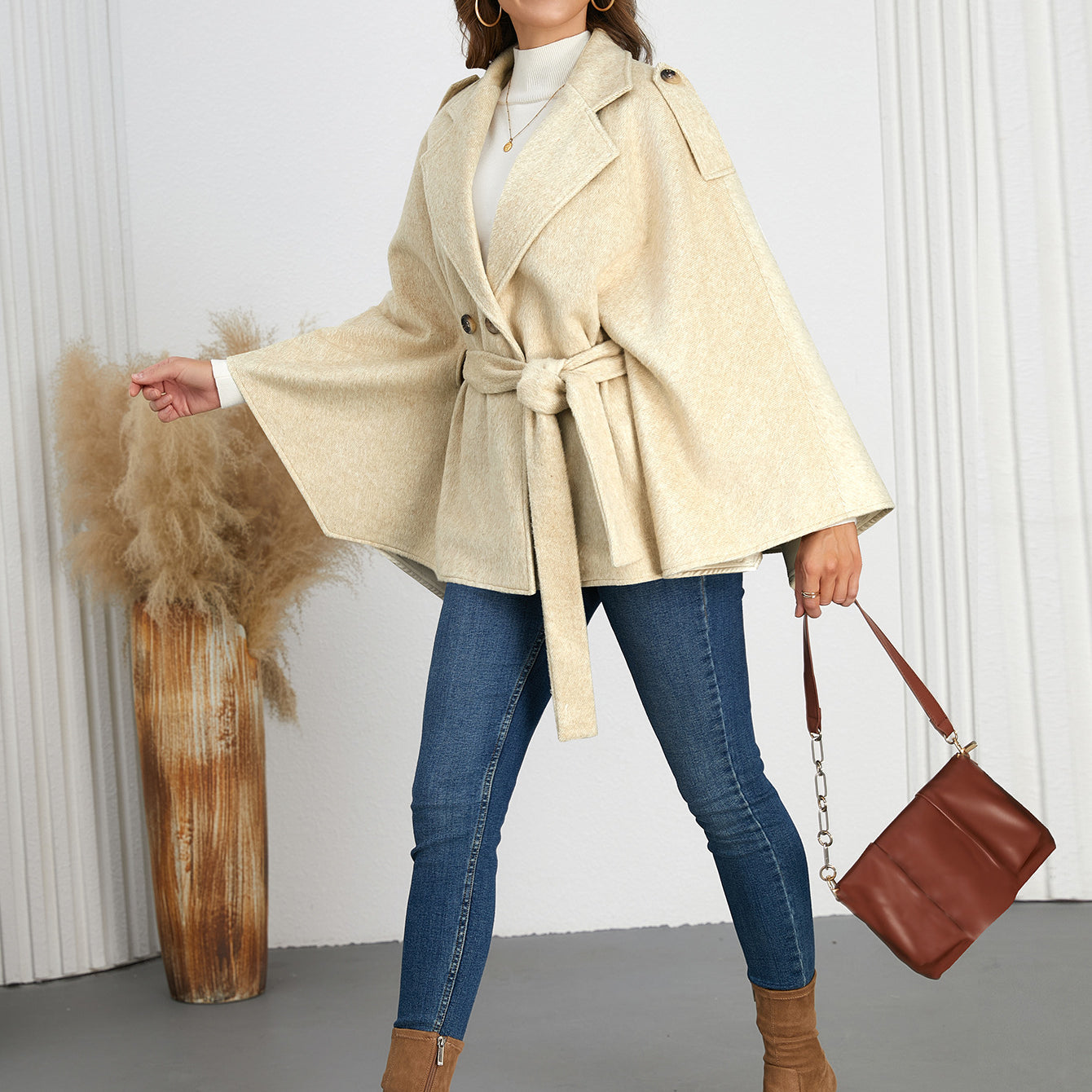 Woman wearing a belted cape coat from Langry, perfect for winter fashion ملابس