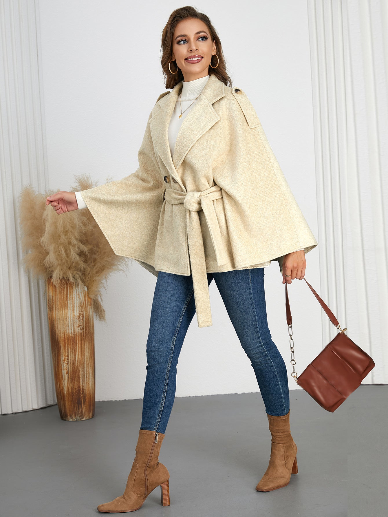 Woman wearing a belted cape coat from Langry, perfect for winter fashion ملابس